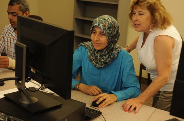 A professor helping a student at the computer