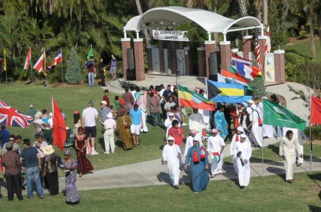 Students holding flags representing their country