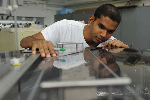 Student cutting steel with a machine