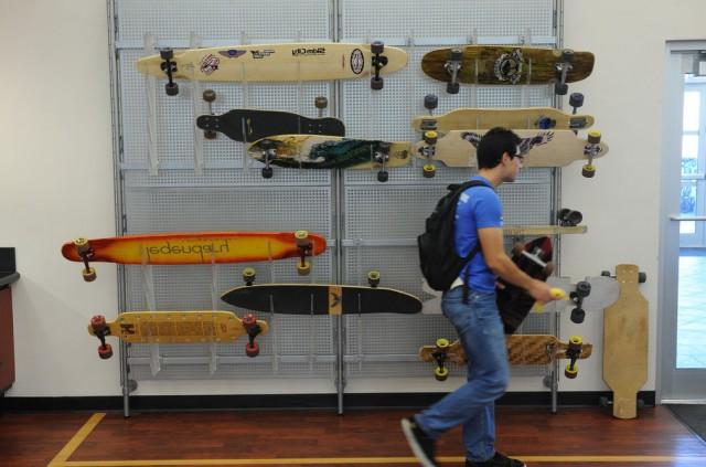 Student walking through a skateboard shop