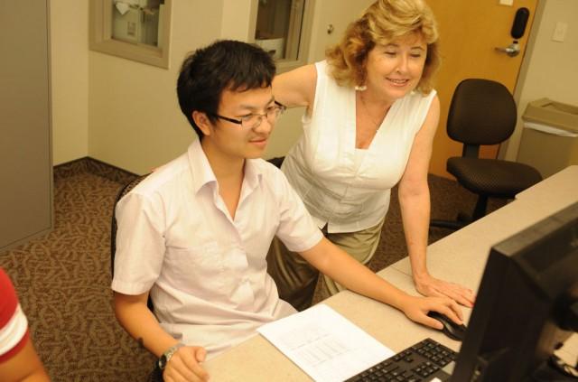 A student being assisted by a professor