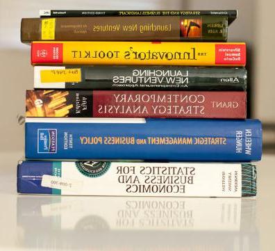 a stack of books with titles for starting up a business