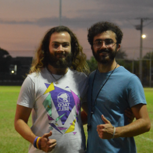 Two student officials smiling and giving thumbs up during an intramural sports competition.